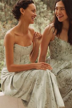 two women sitting next to each other smiling