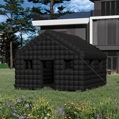 an inflatable house sits on the grass