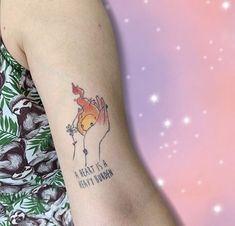 a woman with a tattoo on her arm that says a heart is a fruit bowl