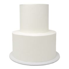 a three tiered white cake sitting on top of a white plate with the bottom half covered in frosting