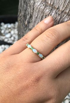 Opal and Emerald Half Eternity Matching Band Ring. Material: Solid Gold or PLATINUM Finishing: High Polished, Shiny Fit: Standard Width: 3.2 mm Height: 3 mm Setting: Prong Stone #1: Natural Opal Shape: Oval Size: 3mm x 5mm Quantity: 5 Opals Stone #2: Natural Emerald Quality: AAA Cut: Round, Diamond Cut Size: 2mm Quantity: 4 Emeralds This band will turn your Engagement Solitaire into a Sophisticated Wedding Set (Bridal Set). It will make your Solitaire Ring to pop out and look more eye catchy and Oval Half Eternity Band For Formal Occasions, Oval Yellow Gold Emerald Ring With Multi-stone, Oval Yellow Gold Emerald Ring With Multiple Stones, Gold Oval Multi-stone Stackable Rings, Green Gemstone Eternity Band For Wedding, Oval Multi-stone Emerald Ring In White Gold, Oval Half Eternity Band In White Gold, Oval White Gold Half Eternity Band, Elegant May Birthstone Eternity Band For Wedding