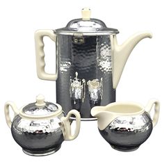 a silver tea set with matching cups and saucers on a white background, in the shape of a kettle