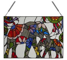 a stained glass window with an elephant and flowers in the center, hanging on a chain