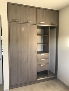 an empty closet with drawers and shelves in it