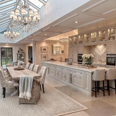 a large kitchen with an island and dining room table