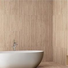 a white bath tub sitting on top of a wooden floor