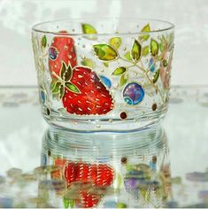 a glass bowl with strawberries painted on it