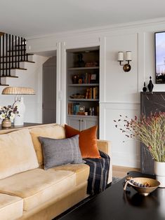 a living room filled with furniture and a fire place