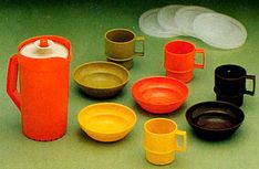 an assortment of different colored cups and saucers