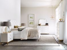 a bedroom with white furniture and gold accents on the walls, carpeted flooring