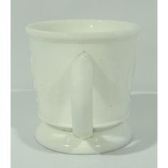 a white cup with a handle on it