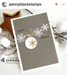 a christmas card with snowflakes on it and some cotton balls in the background