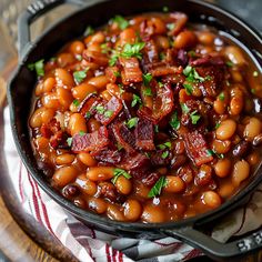 a skillet filled with baked beans and bacon