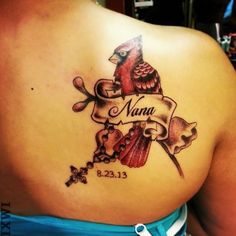 a woman with a tattoo on her back that reads nama and has a bird