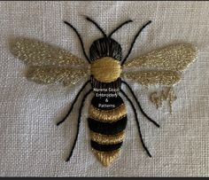 a close up of a bee on a piece of cloth