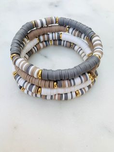 Neutral toned heishi beads in blocked striped pattern and non-tarnish gold accents. Wear multiple bracelets together or mix and match along with custom bracelets. Choose your size and at checkout.  💟Please indicate the desired sizing within the customization section. Sizing length is as follows:  Women's small: 6.5 inches Women's medium: 7 inches Women's large: 7.5 inches Women's XL: 8 inches 💟Listing includes ONE bracelet unless you choose to order the discounted set option.  💟All orders are Color Combinations For Clay Bead Bracelets, Everyday Clay Bead Bracelet Ideas, Clay Bead Bracelet Ideas For Women, Neutral Clay Bracelets, Heishi Bracelet Stack Ideas, Neutral Heishi Bracelets, Summer Bracelets Aesthetic Clay Beads, Disk Bracelet Ideas, Clay Bead Bracelet Ideas Neutral Colors