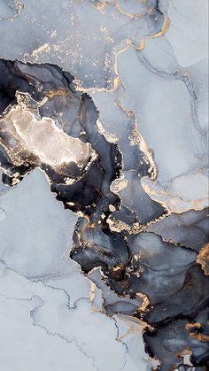 an abstract marble pattern with gold and black paint on the top, as seen from above