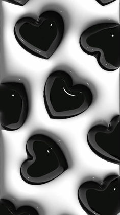 black and white heart shapes are shown in this abstract photo, which appears to be made from liquid