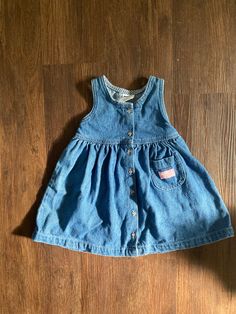 The perfect Osh Kosh B'Gosh denim dress in great vintage condition.  3T VINTAGE POLICY: As with all vintage items, some wear or manufacturing defects may be present. Please remember that these listings are for previously loved and used items... that is part of their charm! Please review the pictures carefully, as they are an important part of the description, and contact me for further information. SHIPPING: I will happily combine shipping when purchasing multiple items from my shop; just contact me for a quote. REFUNDS: Please make sure you love it, all sales are final. I do not offer refunds or exchanges on items. Vintage Denim Blue Denim Dress With Pockets, Vintage Denim Blue Dress With Buttons, Vintage Light Wash Dresses For Spring, Light Wash Vintage Dresses For Spring, Retro Cotton Denim Dress With Pockets, Cute Denim Dress With Pockets, Vintage Denim Blue Dresses With Pockets, Vintage Light Wash Denim Dress, Vintage Light Wash Summer Dress