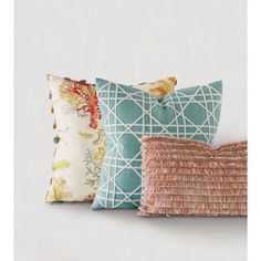 four decorative pillows in various colors and patterns