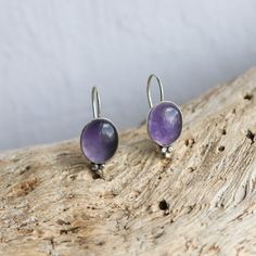 These are wonderful soft purple Amethyst drop earrings. The Lavender Amethyst color is perfect! This is the Piper Earring design -- new at LBJ -- but soon to be a favorite! And we couldn't love it more than here in this fabulous, soft purple Amethyst. Modern and traditional at the same time! Minimal embellishments except for the trio of sterling silver beads ... just enough to add mystique to these purple Amethyst drop earrings. All .925 Sterling Silver -- oxidized, sanded and burnished to the p Purple Earrings With Natural Stones, Purple Natural Stones Round Earrings, Round Purple Earrings With Natural Stones, Handmade Amethyst Purple Earrings, Lavender Amethyst Earrings With Natural Stones, Purple Natural Stone Drop Earrings, Lavender Amethyst Round Earrings, Purple Teardrop Earrings With Natural Stones, Teardrop Purple Earrings With Natural Stones