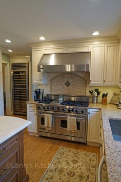 a kitchen with an oven, stove and sink in the middle of the countertop