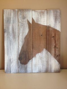 a horse painted on wooden planks in the shape of a barn board wall hanging