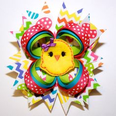 a colorful brooch with a yellow bird on it