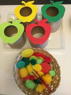 an assortment of apples in plastic containers on a table