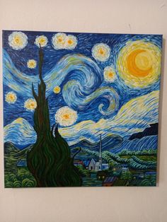 a painting is hanging on the wall in front of a white wall with a blue sky and yellow stars