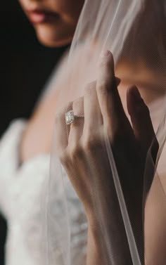 a woman wearing a wedding ring and veil