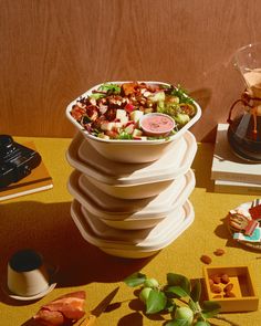 a large salad sitting on top of a table next to other foods and condiments