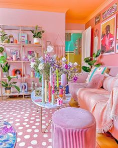 a living room filled with lots of furniture and flowers on top of a coffee table