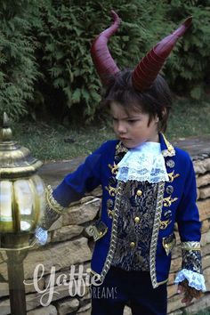 a young boy dressed in costume with horns on his head