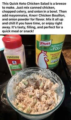 a glass bowl filled with chicken salad next to a bottle of mayonnaise