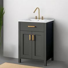 a bathroom vanity with a sink and gold faucet on the top, against a white wall