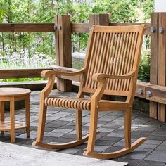 a wooden rocking chair sitting on top of a patio