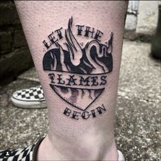 a person with a tattoo on their leg that says let the flames begin