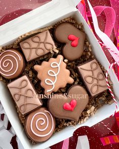 a box filled with lots of decorated cookies