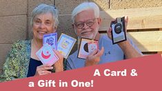 two elderly people holding up cards with the words a gift in one and an image of a camera