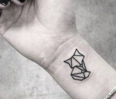 a black and white photo of a woman's wrist tattoo