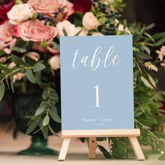 a table number sitting on top of a wooden easer