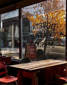 an empty table and chairs in front of a window with the words dopeta cycles market on it