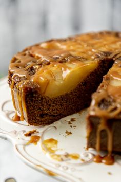 a chocolate cake with caramel drizzled on top and one slice cut out