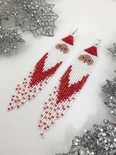 Santa shoulder duster earrings long Christmas seed bead | Etsy Beaded Earrings Patterns Free, Beaded Hoop Earrings Native American, Christmas Seed Bead, Christmas Jewerly, Seed Bead Bracelet Patterns, Duster Earrings, Shoulder Duster Earrings, Blue Beaded Earrings, Beaded Jewelry Earrings