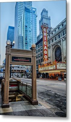 the chicago theater marquee is located in front of some tall buildings and skyscrapers