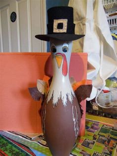 an egg with a turkey wearing a top hat on it's head sitting on a table