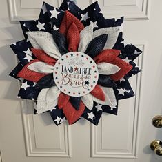 a red, white and blue patriotic wreath on a door