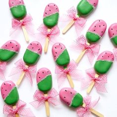 watermelon lollipops with pink bows and green on them are arranged in a circle