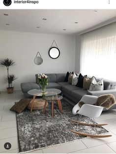 an image of a living room setting with furniture and decor on the floor, including couches